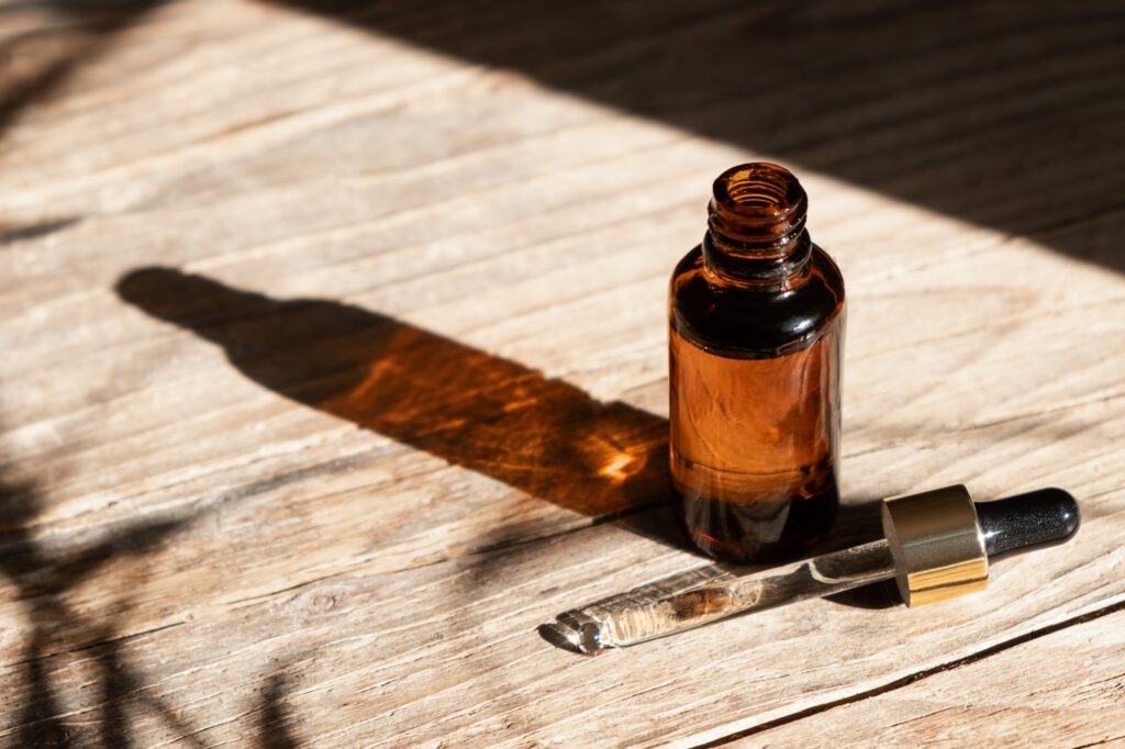 Dark amber glass bottle with dropper for oil