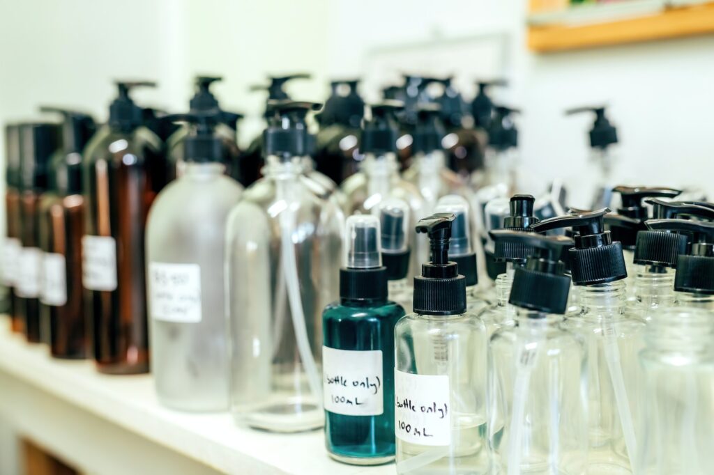 Different sizes pumping and spray bottles, recycling materials in a shop. Zero waste concept