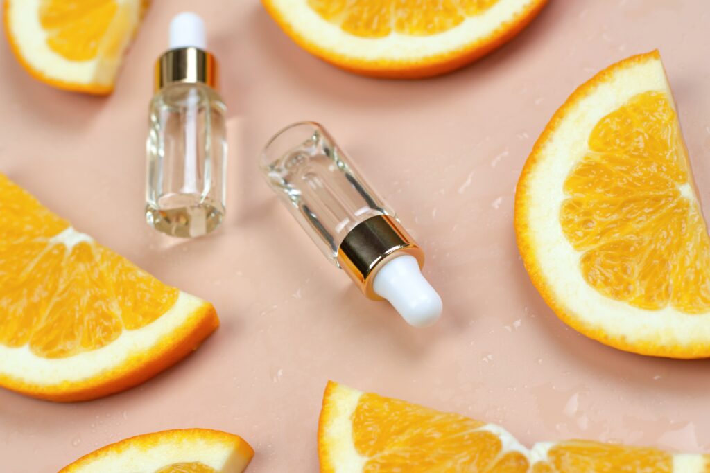 Orange oil in a bottle with a dropper and orange slices