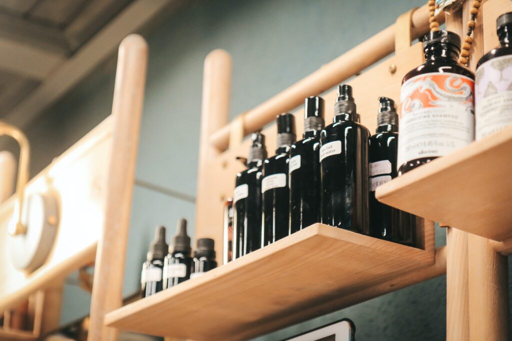 Shelf of black bottles of cosmetic products