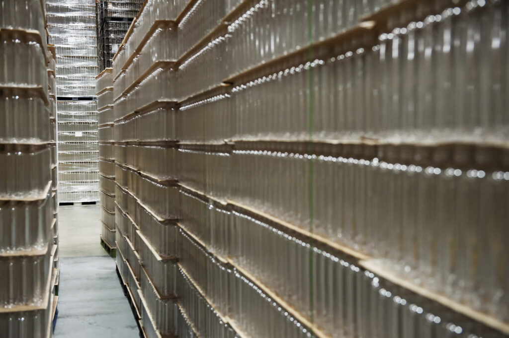 Glass bottles stacked in warehouse