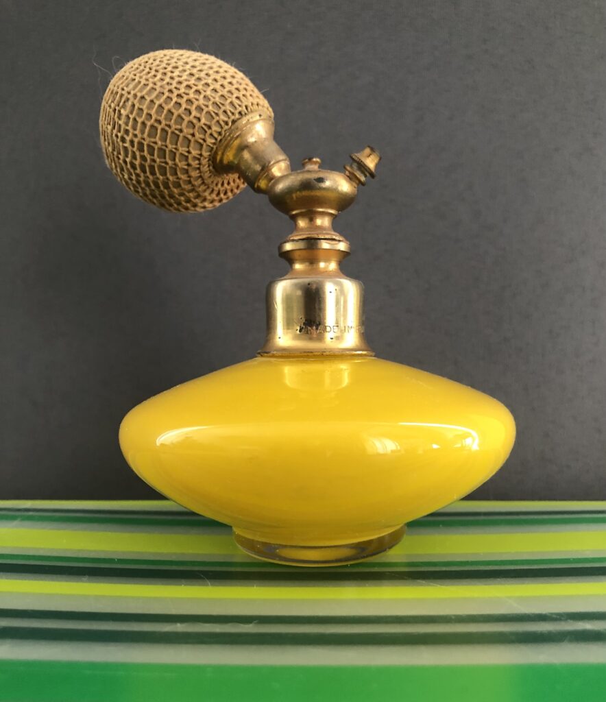 Vintage perfume bottle in yellow glass